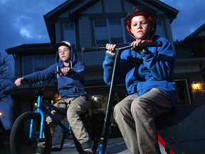 Jett Patola, age 10, and his brother Cole, 12, on the driveway of their Lake Chaparral home Sunday, March 27, 2016. The family had a home made skateboard ramp taken after someone advertised it on Kijiji without their permission while they were away.