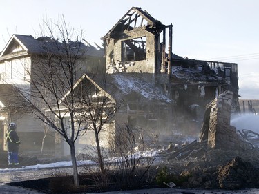 Two badly damaged homes are pictured at the scene of an overnight fire in Kincora.