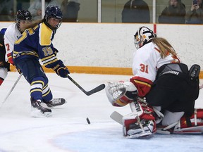 Laurentian Voyageurs Ellery Veerman watches her her shot as it goes past Guelph Gryphons goalie Valerie Lamenta during OUA women's playoff hockey action in Sudbury, Ont. on Wednesday February 24, 2016. Gino Donato/Sudbury Star/Postmedia Network