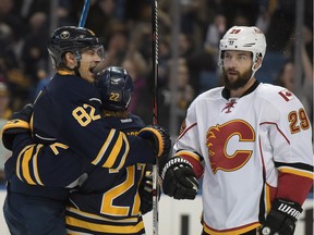 Calgary Flames' Deryk Engelland looks on as Buffalo Sabres' Marcus Foligno (82) celebrates with Johan Larsson (22) after Larsson scored during  the third period of their game in Buffalo Thursday night.
