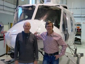 Mel O"Reilly, founder of Eagle Helicopters who has been recognized by international helicopter pilot organization, Twirly Birds, and his son Mike who is the company's chairman.