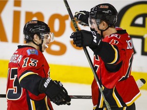 Mikael Backlund, right, celebrates his game-winning goal with Flames teammate Johnny Gaudreau in Calgary's 3-2 overtime win over the Nashville Predators on Wednesday at the Saddledome.