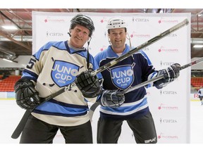 NHL alum Mark Napier (L) and country artist Gord Bamford mug for a photo before a Juno Cup practice game at Max Bell Centre in Calgary, Alta., on Thursday, March 31.