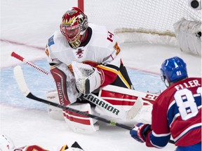 Calgary Flames goalie Niklas Backstrom makes a save off Montreal Canadiens' Lars Eller during second period NHL hockey action Sunday, March 20, 2016 in Montreal.