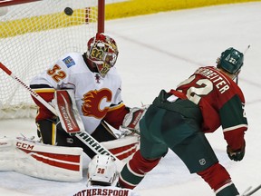 Minnesota Wild's Nino Niederreiter, right, of Switzerland scores on Calgary Flames goalie Niklas Backstrom of Finland in the third period of an NHL hockey game, Thursday, March 24, 2016, in St. Paul, Minn. The Wild won 6-2.