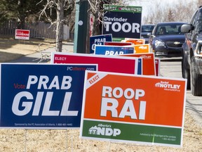 Campaign signs fill an Abbeydale curbside in Calgary on Saturday, March 19, 2016.