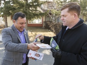 PC candidate Prabhdeep Gill and Wildrose leader Brian Jean good-naturedly exchange pamphlets after randomly crossing paths while door-knocking in the Abbeydale area of Calgary, Alta., on Saturday, March 19, 2016. Gill is the PC candidate in the upcoming Calgary-Greenway provincial byelection to replace Manmeet Bhullar, who was killed in a highway accident on Nov. 23, 2015.