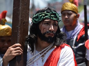 Actors playing the role of Jesus and Roman soldiers reenact the suffering and crucifixion of Jesus.