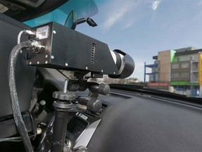 A Calgary Police Service peace officer operates a photo radar camera on 9 Ave SE in Inglewood in a playground zone on Sunday, March 27, 2016.