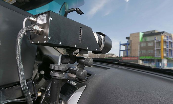 A Calgary Police Service peace officer operates a photo radar camera on 9 Ave SE in Inglewood in a playground zone on Sunday, March 27, 2016.