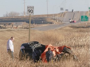 RCMP examine a vehicle in the east ditch on scene of a double fatal accident on Hwy 797 near Twp Rd 240, about 3 km north of Langdon, Alta, east of Calgary on Friday March 27, 2015. Multiple patients were taken by ground and by STARS Air Ambulance to hospital on Calgary and two patients were deceased at the scene. Jim Wells//Postmedia