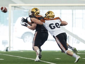 Michael Schmidt (left) from the University of Calgary and DJ Lalama from the University of Manitoba run a drill during the CFL Regional Combine held at Commonwealth Recreation Centre in Edmonton, Alta., on Monday March 7, 2016. Players who moved on will attend the national combine.