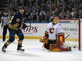 Buffalo Sabres' Sam Reinhart (23) celebrates a goal by Jack Eichel as Calgary Flames' Jonas Hiller (1) reacts during the third period of an NHL hockey game, Thursday, March 3, 2016, in Buffalo, N.Y. Buffalo won 6-3.