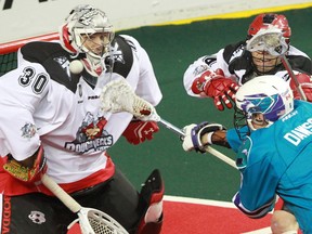 Calgary Roughnecks goaltender Mike Poulin stops this scoring chance by the Rochester Knighthawks'  Dan Dawson during National Lacrosse League action at the Scotiabank Saddledome in Calgary on Saturday March 5, 2016. Calgary lost 9-8 in overtime.