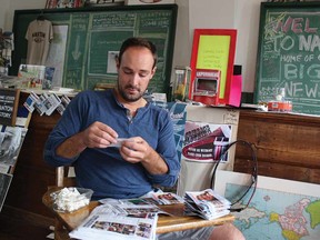 Peter Worden works diligently on his miniature newspaper The Nanton Experiment.