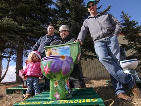 Left to Right: Kevin Gelinas - with daughter Paisley - Sean Pitt and Mike Hewitt with toilets they decorated for the Game of Thrones Fundraiser for the Enbridge Ride to Conquer Cancer in Calgary, Ab., on Thursday March 17, 2016. Mike Drew/Postmedia