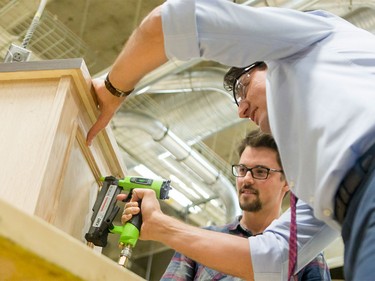 Prime Minister Justin Trudeau helps fourth-year carpentry student Mitch Beaudet with a project at SAIT Polytechnic in Calgary, Alta., on Tuesday, March 29, 2016. Trudeau was part of a roundtable discussion on employment insurance at the Kerby Centre before touring a carpentry lab at SAIT Polytechnic.