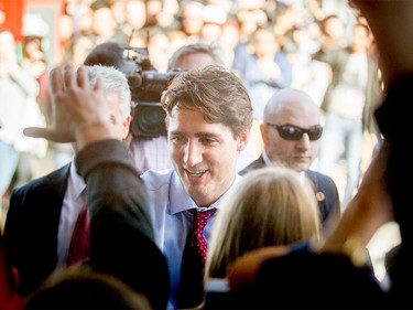 Prime Minister Justin Trudeau greets students upon his arrival at SAIT Polytechnic in Calgary, Alta., on Tuesday, March 29, 2016. Trudeau was part of a roundtable discussion on employment insurance at the Kerby Centre before touring a carpentry lab at SAIT Polytechnic.