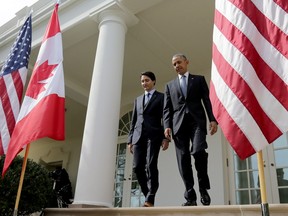 U.S. President Barack Obama and Canadian Prime Minister Justin Trudeau walk from the Oval Office to a joint press conference in the Rose Garden of the White House on Thursday.