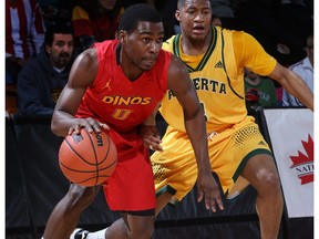 U of C Dinos #0 David Kapinga  drives to the hoop against  U of A #3 Colby Jackson during Canada West Basketball playoffs at the Jack Simpson Gym Saturday night. Photo by David Moll, Dinos Athletics