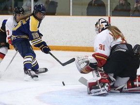 Laurentian Voyageurs Ellery Veerman watches her shot as it goes past Guelph Gryphons goalie Valerie Lamenta during OUA women's playoff hockey action in Sudbury, Ont. on Wednesday, February 24, 2016. Gino Donato/Sudbury Star/Postmedia Network