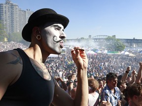 A man smokes marijuana as thousands of people gather at 4/20 celebrations last year in Vancouver.