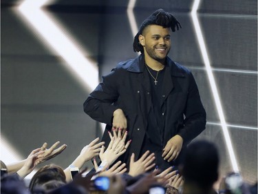 The Weeknd accepts the award for Album of the Year for his album Beauty Behind the Madness during the Juno Awards at the Scotiabank Saddledome in Calgary, Alta., on Sunday, April 3, 2016. The Juno Awards celebrate the best in Canadian music. Lyle Aspinall/Postmedia Network