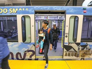 Natalie Sit rides the CTrain out of downtown, taking her one-year-old daughter, Rosil, to get immunized. Sit says she only misses two aspects of her former life with a vehicle: car washes and drive-thrus. 