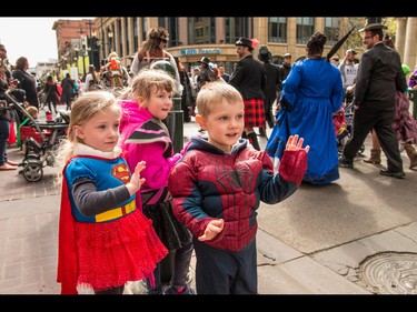 Alyssa Kryschuk, Cole Griswold and Emma Sawin wave at the passing cosplayers at the annual Parade of Wonders that kicks off the Calgary Comic & Entertainment Expo at the BMO Centre in Calgary, Ab., on Friday April 29, 2016. Mike Drew/Postmedia