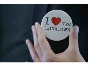 A supporter shows a button in Calgary, Alta at the Chinese Cultural Centre on Sunday April 10, 2016. A group of performers and suppoters gathered at a rally about potential changes to Chinatown in Calgary.
