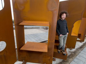 Artist Adad Hannah poses for a photo with his sculpture 'The Fold' outside of the Quarry Park recreation centre currently under construction in Calgary on Wednesday, April 27, 2016. Hannah, who lives in Vancouver and Montreal, says The Fold is made from self-weathering steel and is designed to be interactive.