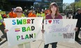 Two supporters, on opposite sides of the southwest BRT issue, hold their signs at a rally at City Hall in Calgary on Wednesday, April 20, 2016.