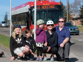 Calgary Transit bus driver Mark Boody, poses with the Urban family including mom Kerry and kids from left; Carter, 11, Drew, 8, and Poppy, 4.  Boody was stopped for the family at a crosswalk on Heritage Drive when he noticed a driver speeding down the outside lane and not slowing down. He used his horn to warn Kerry which also alerted the driver of the car who screeched to a halt a the last second. The family and transit talked about the close call on Thursday, April 7, 2016.