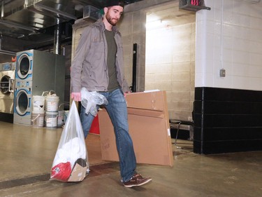 The Calgary Flames' TJ Brodie heads out of the Scotiabank Saddledome as the team cleared out their lockers for the season on Monday, April 11, 2016.