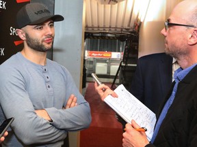 Calgary Flames captain Mark Giordano talks to Calgary Herald sports columnist Scott Cruikshank at the Scotiabank Saddledome as the team cleared out their lockers for the season on Monday, April 11, 2016.