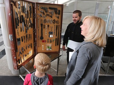 Visitors check out weapons seized in the past at the security area of the Calgary Courts Centre on Law Day 2016 - Saturday, April 16, 2016.