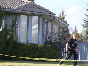 Calgary Police investigate at a home on Woodridge Close SW in Calgary, Alta on Wednesday April 27, 2016. Police were called around 3 a.m. to the home to respond to reports of a woman in medical distress. Officers found Melissa Couture, 38, of Calgary, unresponsive in the home and pronounced her dead. The death was later deemed suspicious and the homicide unit was notified. An autopsy is underway to determine the manner of Couture's death. Her mother, Patricia Couture, 68, of Calgary, has been charged with failure to provide the necessaries of life.