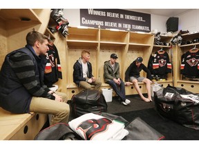 Hitmen players from left; Radel Fazleev, Michael Zipp, Colby Harmsworth, and Travis Sanheim sit and talk as they clean out their lockers at the Saddledome on Monday.