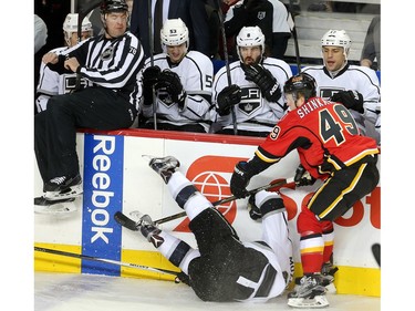 Hunter Shinkaruk, in his first game for the Calgary Flames at the Saddledome, knocks over Jake Muzzin of the Los Angeles Kings during the first period Tuesday April 5, 2016.