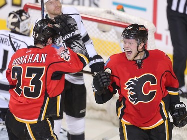 Hunter Shinkaruk of the Calgary Flames, right,  celebrates with linemate Sean Monahan after scoring his first goal at the Saddledome during the second period Tuesday April 5, 2016 against the Los Angeles Kings.