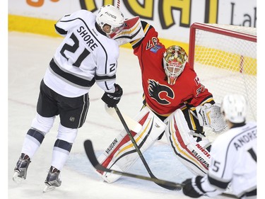 Calgary Flames goalie Joni Ortio holds off Nick Shore of the Los Angeles Kings in his crease at the Saddledome during the first period Tuesday April 5, 2016.