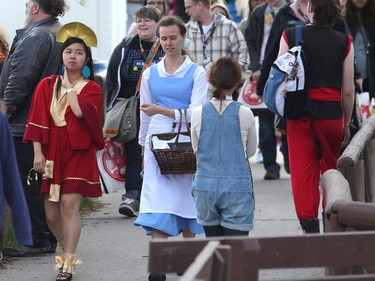 Phoebe Kwan, left, and Brenna Davies join the crowds heading to the BMO Centre as the doors open on this year's Calgary Comic and Entertainment Expo Thursday, April 28, 2016.