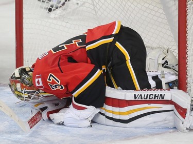Calgary Flames goalie Joni Ortio crumbles to the ice after being scored on by the Los Angeles Kings in the final minute forcing overtime and an eventual loss at the Saddledome Tuesday April 5, 2016.