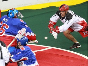 Calgary Roughnecks' Jeff Shattler, right, scores on Toronto Rock goalie Nick Rose during National Lacrosse league action at the Scotiabank Saddledome on April 30, 2016.