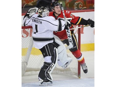 Micheal Ferland of the Calgary Flames runs into Los Angeles Kings netminder Jhonas Enroth in the third period at the Saddledome Tuesday April 5, 2016.
