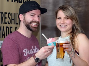 James Boettcher of Fiasco Gelato shares his product with Nicole Romanow of Village Brewery during a scoop and pour launch party  April 7, 2016 at Village Brewery. Village and Fiasco Gelato teamed up on a lemon and raspberry summer time brew and sorbetto. Nicole's parents are pictured on the beer box. (Ted Rhodes/Postmedia)