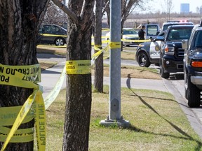 Police tape mark the scene of a suspicious death in an alley behind the 9700 block of Harvest Hills Link in Calgary, Alta., on Thursday, April 7, 2016.  GAVIN YOUNG/POSTMEDIA