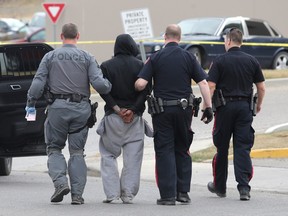 A suspect is taken into custody by Calgary police on 76 Street at 112 Avenue NW Tuesday April 12, 2016 following a stolen vehicle pursuit that lasted for hours all over the city.