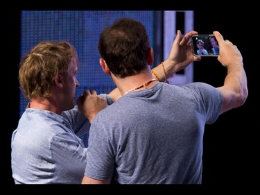 Jason Isaacs (R) and Tom Felton, the Malfoys from the Harry Potter films, shoot a selfie from the stage during their panel during the Calgary Comic and Entertainment Expo at Stampede Park in Calgary, Alta., on Sunday, May 1, 2016. Lyle Aspinall/Postmedia Network