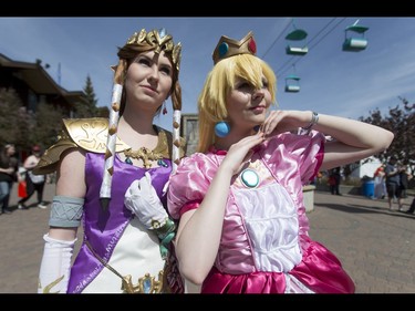 Charlotte Olstad, as Princess Zelda, and Brooklyn Whyte, as Princess Peach, strike a pose during the Calgary Comic and Entertainment Expo at Stampede Park in Calgary, Alta., on Sunday, May 1, 2016. Lyle Aspinall/Postmedia Network